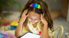Young girl looking at a tablet device.